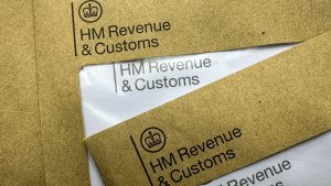 HMRC debt tax letters. Brown HMRC envelopes. An envelope from the UK tax office HM Revenue and Customs.